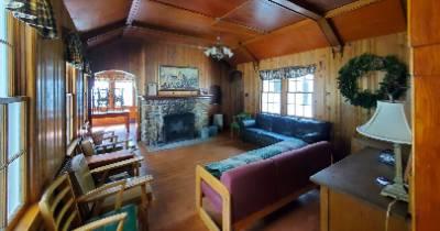 Lodge building living area with couches and fireplace